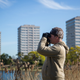 A man looks for birds through a pair of binoculars. Image: Rob Stothard/Getty Images